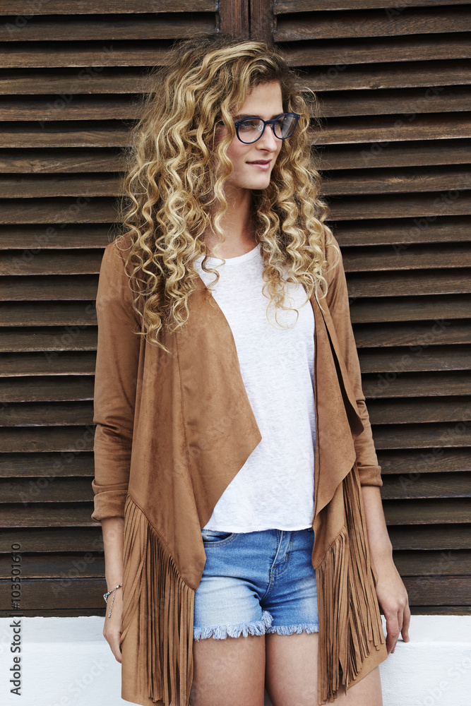 Fototapeta premium Beautiful woman in spectacles and suede jacket