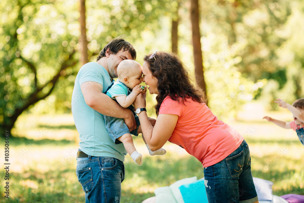 Young family with kids having picnic outdoors. Young family with kids having picnic outdoors.