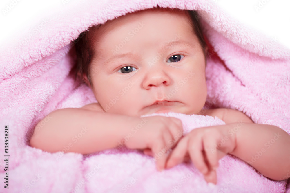 Newborn baby girl on a soft pink terry towel Newborn baby girl on a soft pink terry towel
