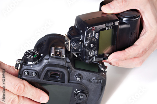Photographer set external flash on digital SLR camera