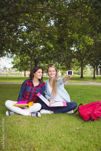 Smiling students taking a selfie outdoor 