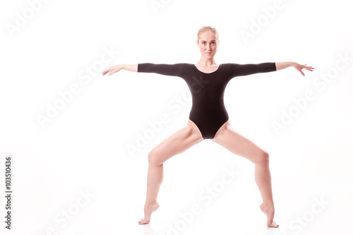 ballet dancer smiling in black swimsuit standing on tiptoes