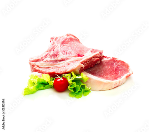 Pieces of raw beef with tomato and salad isolated on white background