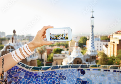 Photography Closeup on female tourist taking photos in Park Guell, Barcelona