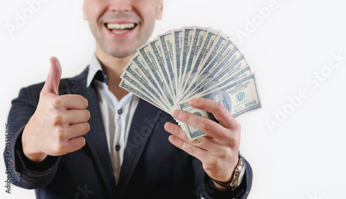 Businessman with bundle of money in studio on a white background