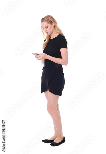 Full length portrait of an attractive professional woman wearing black dress suite and heels, isolated on a white background.