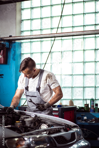 Repairman laboring in workshop