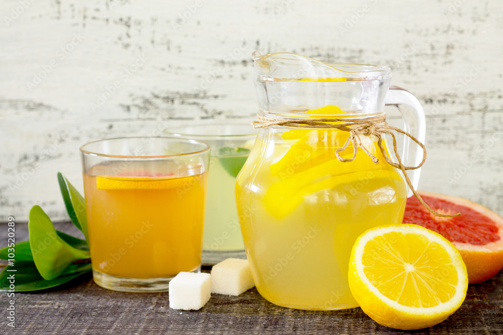 Citrus juices with fresh fruit on wooden table Citrus juices with fresh fruit on wooden table