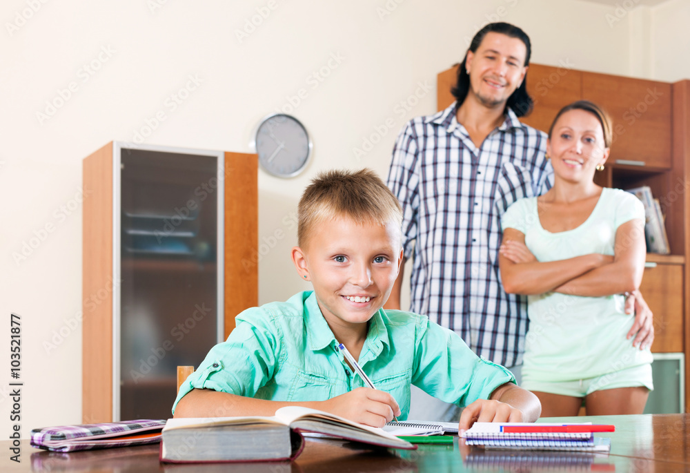 Fototapeta premium parents watching their son doing homework