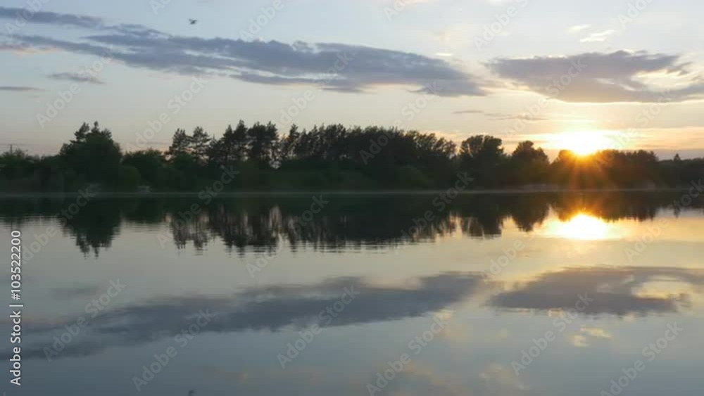Sunset on The River Silhouettes of Trees And Sky Reflection in Water Birds are Flying upon a River Sun Rays though a Top of Trees Evening Summer Spring Sunset on The River Silhouettes of Trees And Sky Reflection in Water Birds are Flying upon a River Sun Rays though a Top of Trees Evening Summer Spring