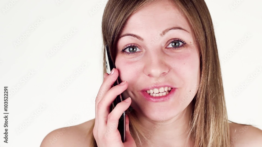 Beautiful womanTalking on The Phone. White background. Beautiful womanTalking on The Phone. White background.