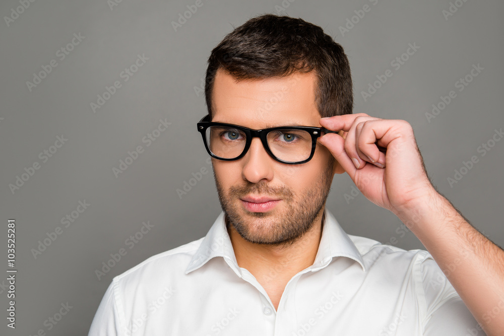 Obraz premium Smart man touching his glasses