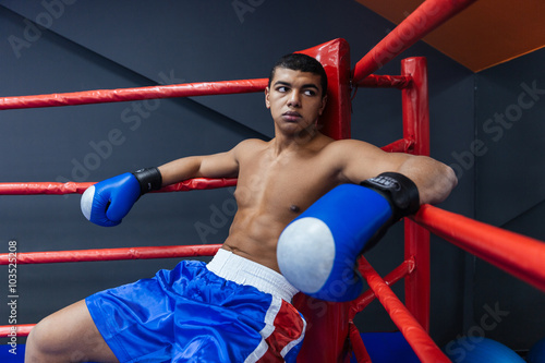 Boxer sitting in boxing ring