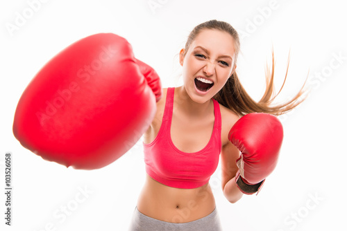 Beautiful angry sportswoman in red boxing gloves