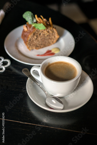 coffee cup with cake on table in cafe