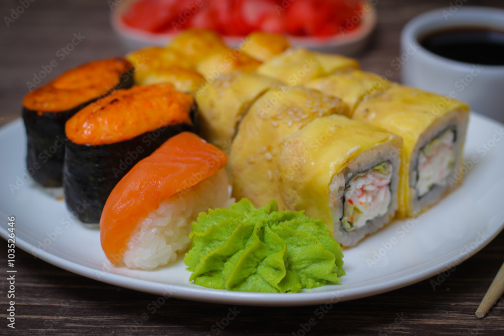 Japanese food seafood sushi , roll and chopstick on a white plate Japanese food seafood sushi , roll and chopstick on a white plate