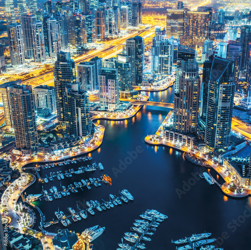 Dubai Marina skyline by night with lluminated architecture. United Arab Emirates.
