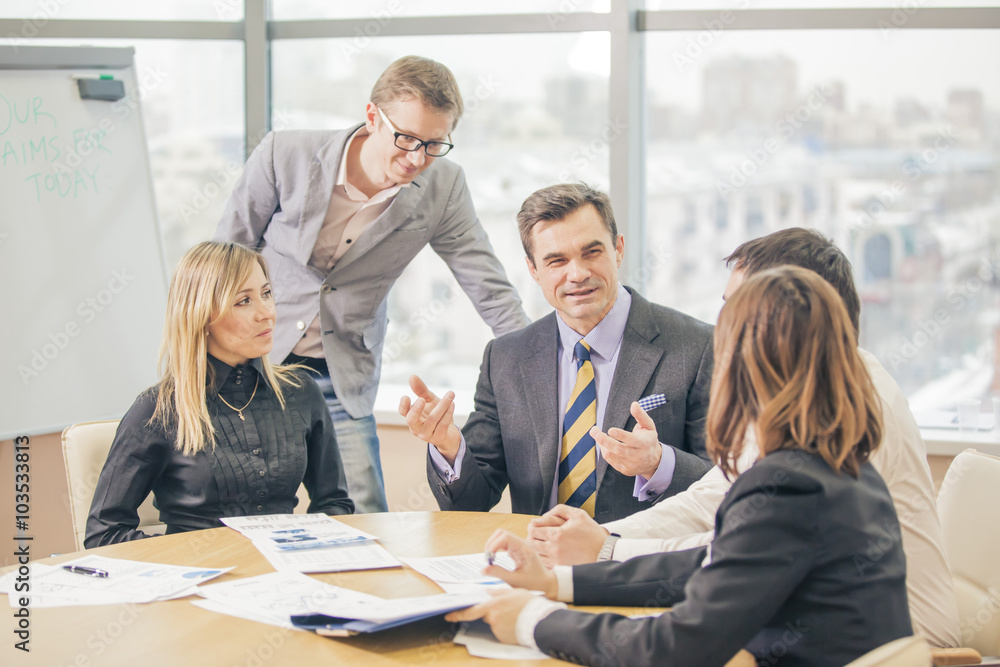 several businesspeople interacting at meeting several businesspeople interacting at meeting
