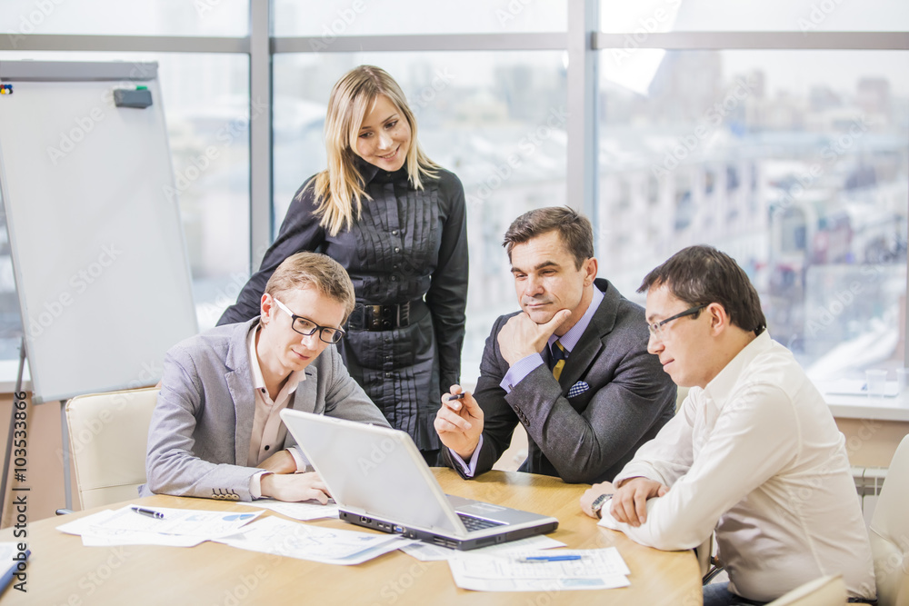 a few businessmen or colleagues look at the monitor and communicate a few businessmen or colleagues look at the monitor and communicate