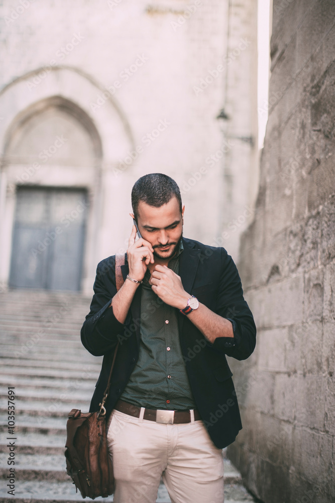 Portrait of young bearded man talking on his phone Portrait of young bearded man talking on his phone