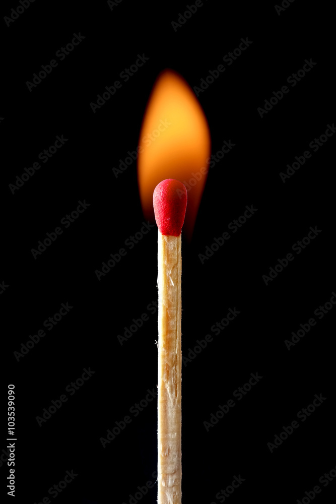 Burning match isolated on black background