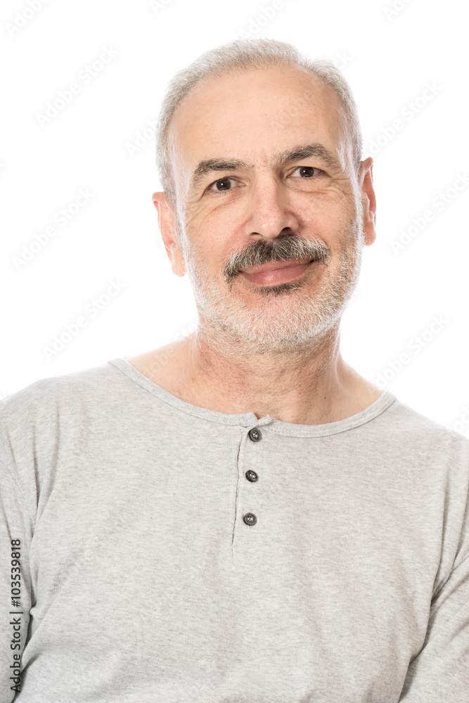 Obraz premium Close up portrait of a smiling attractive senior man looking dir