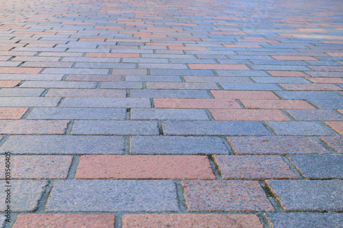 Cement brick floor background. Selective focus.