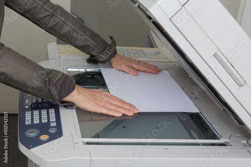 Woman hand with working copier at work office for business photo