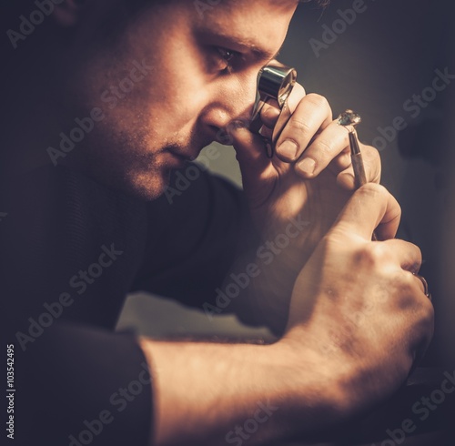 Portrait of a jeweler during the evaluation of jewels. photo