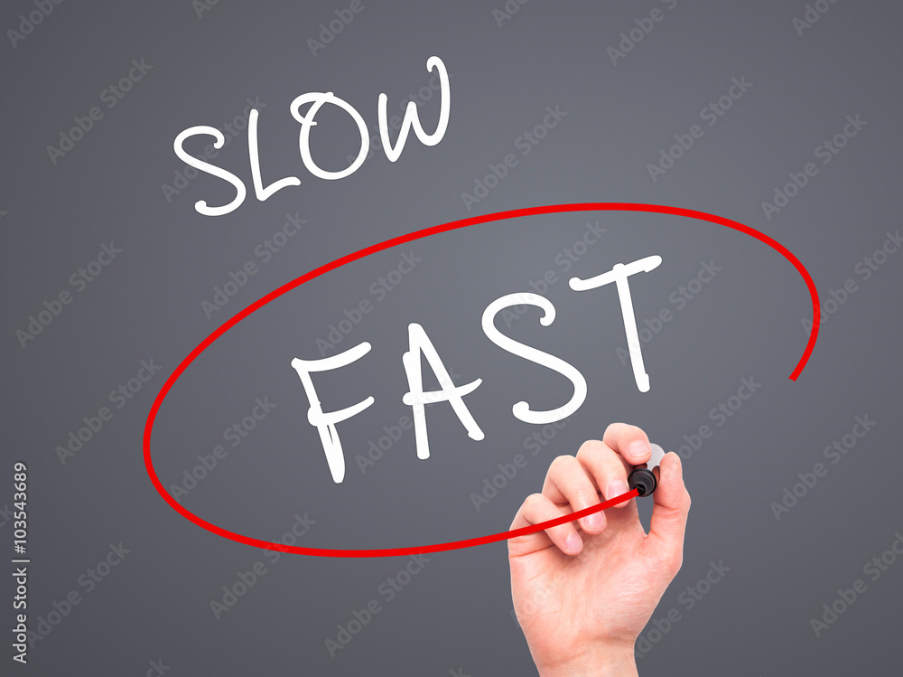 Man Hand writing and Choosing Fast instead of Slow with black ma