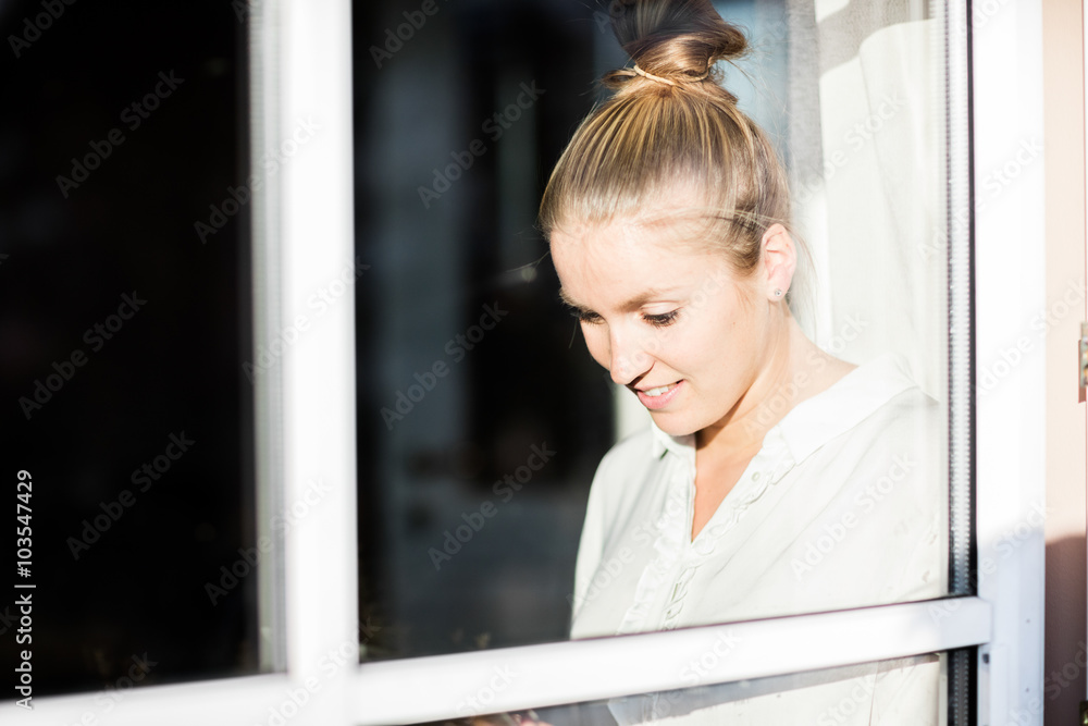 Woman sitting at Window with tablet Woman sitting at Window with tablet