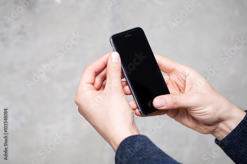 Close up of a man using mobile smart phone