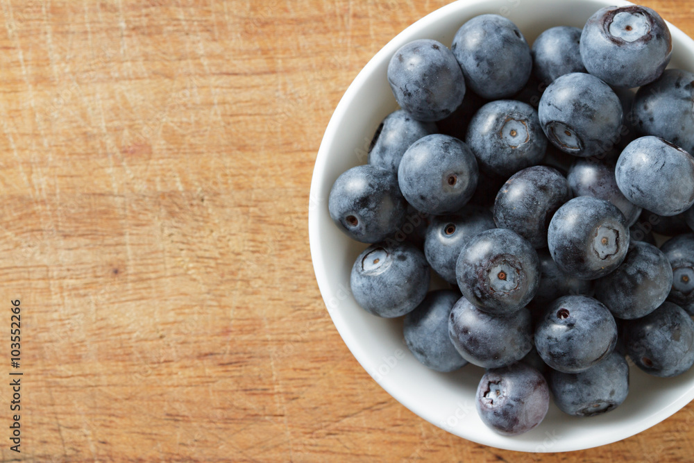 Blueberries in bowl on wooden. Blueberry contain antioxidant org Blueberries in bowl on wooden. Blueberry contain antioxidant org