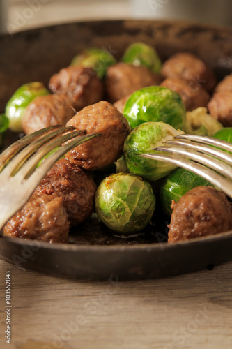 meatballs with cabbage and basil in a pan
