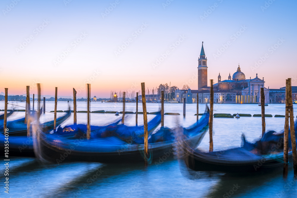 Venetian gondolas and San Giorgio di Maggiore church in background at morning before sunrise, long time exposure, Venice (Venezia), Italy, Europe
