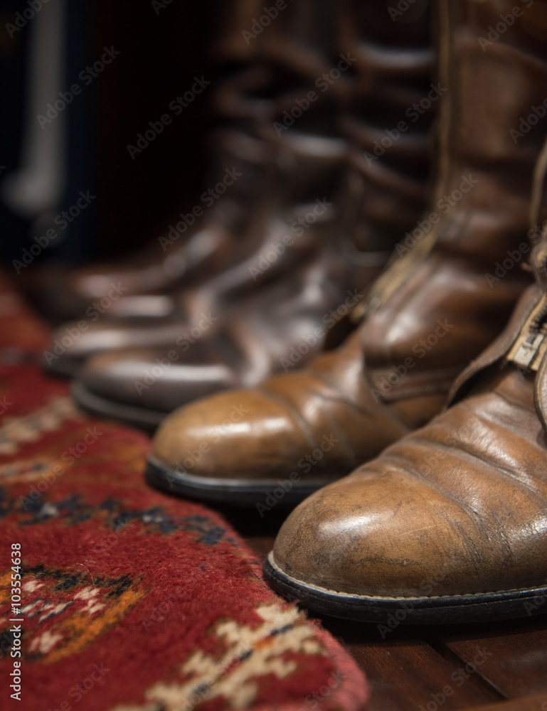 Worn Leather Boots with Patterned Carpet