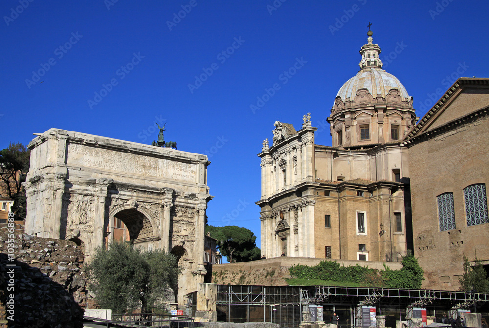 ROME, ITALY - DECEMBER 21, 2012: Arch of Septimius Severus and church of Santi Luca e Martina at the Roman Forum, Rome, Italy
