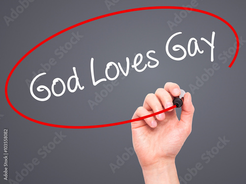 Man Hand writing God Loves Gay with black marker on visual scree