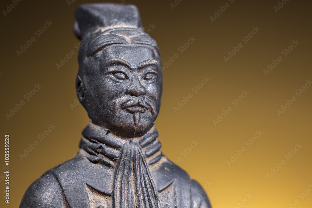 Close-up of terracotta figurine of ancient chinese warrior on rising sun background