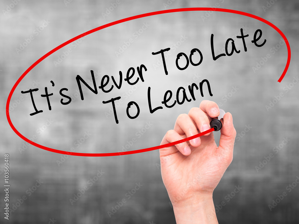 Man Hand writing Its Never Too Late To Learn with black marker o Man Hand writing Its Never Too Late To Learn with black marker o