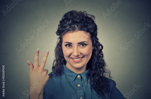 portrait of young pretty woman giving a three fingers sign gesture