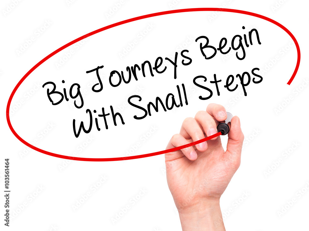 Man Hand writing Big Journeys Begin With Small Steps with black Man Hand writing Big Journeys Begin With Small Steps with black