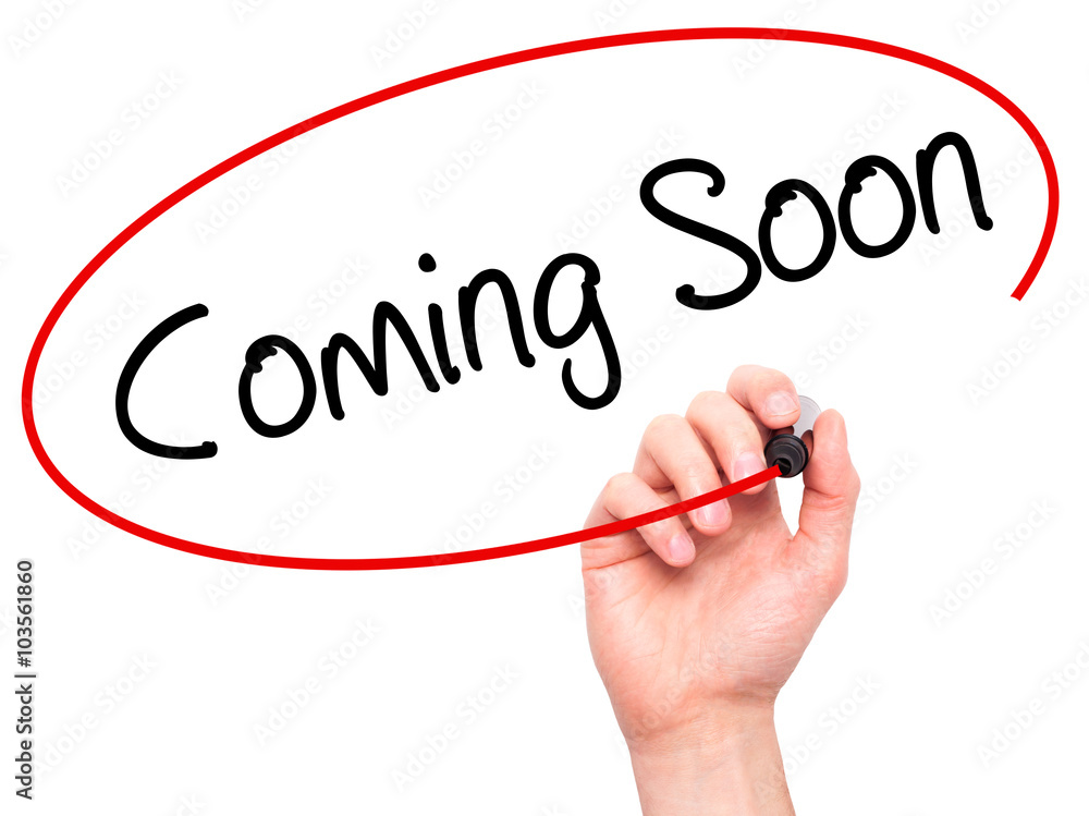 Man Hand writing Coming Soon with black marker on visual screen Man Hand writing Coming Soon with black marker on visual screen