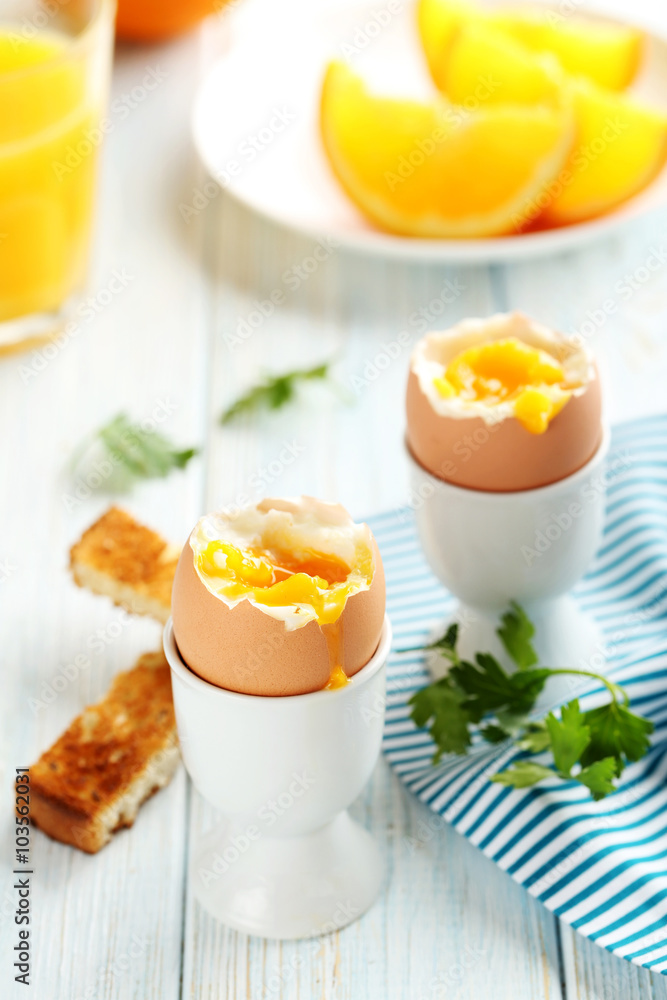 Boiled egg with toasts on a blue wooden table Boiled egg with toasts on a blue wooden table