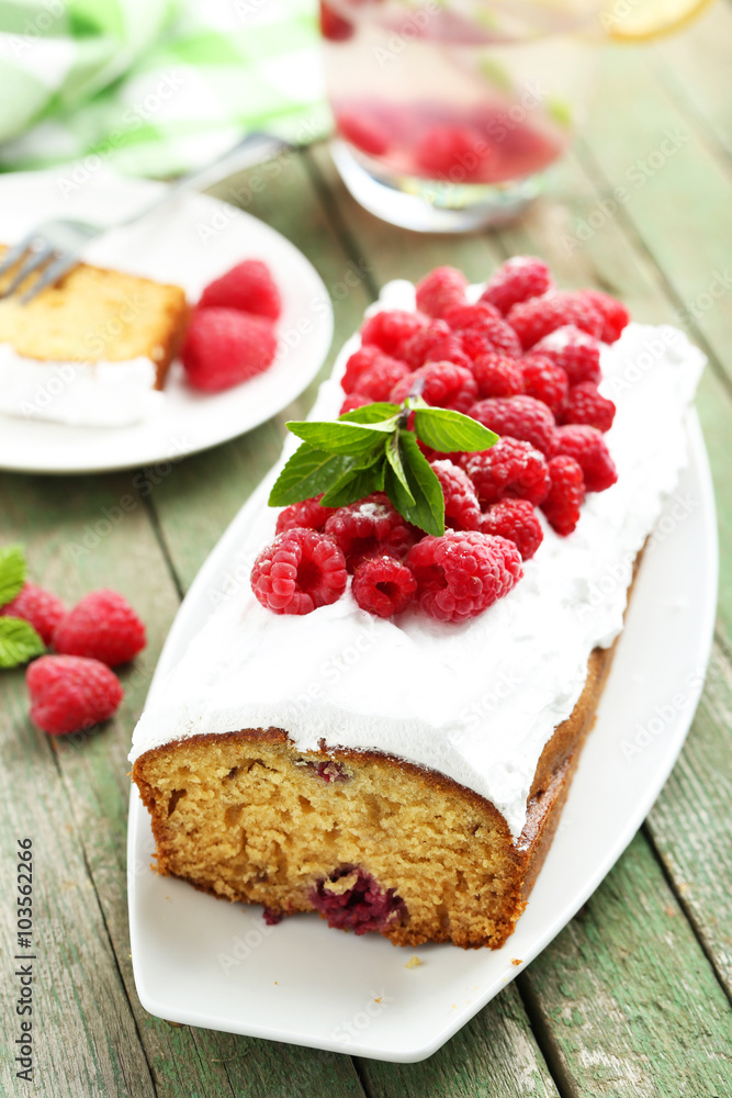 Raspberry cake on plate on green wooden background Raspberry cake on plate on green wooden background