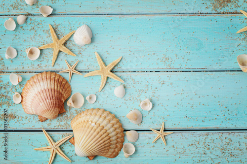 seashells and sand on wooden background