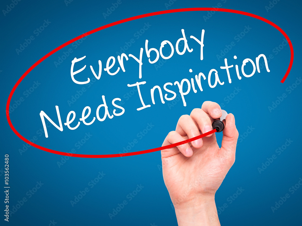 Man Hand writing Everybody Needs Inspiration with black marker o Man Hand writing Everybody Needs Inspiration with black marker o