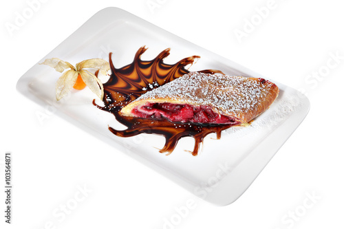 Slice cherry strudel on white ceramic plate rectangular shape.