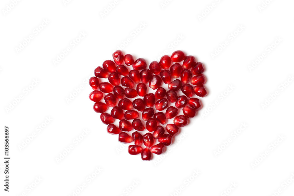 Heart of pomegranate seeds on a white background.