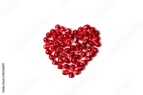 Heart of pomegranate seeds on a white background.